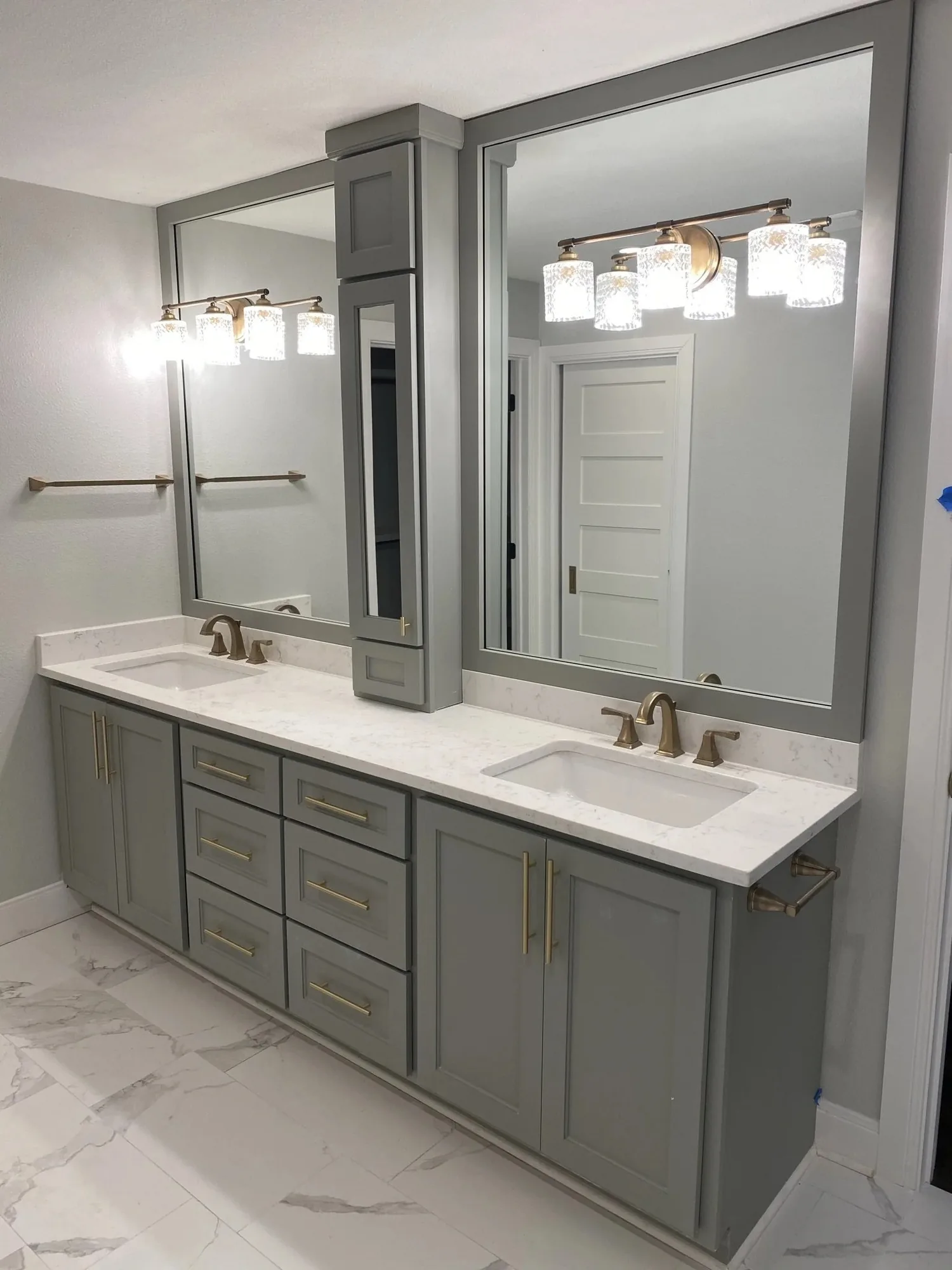 Custom bathroom vanity with double sinks and a framed mirror
