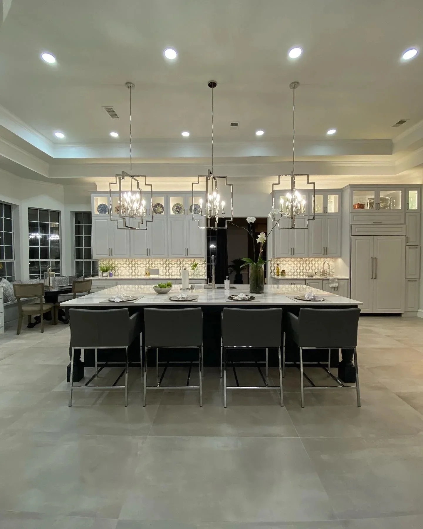 High end kitchen cabinets with a long island and pendant lighting