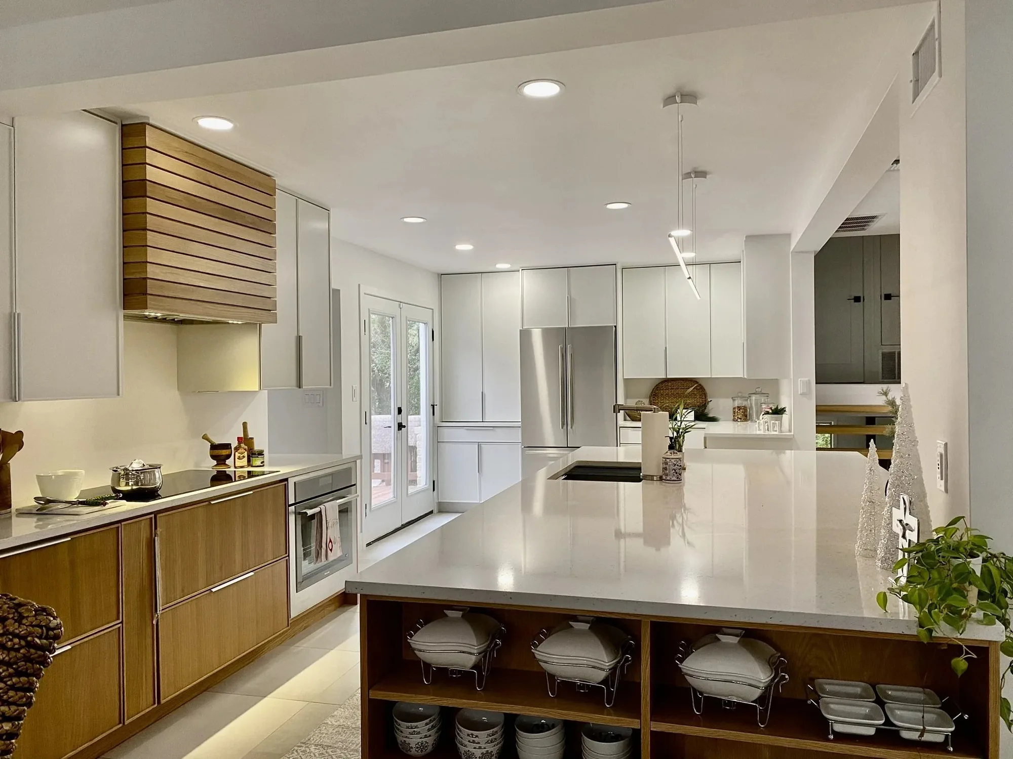 White kitchen cabinets with a wood island and open shelving